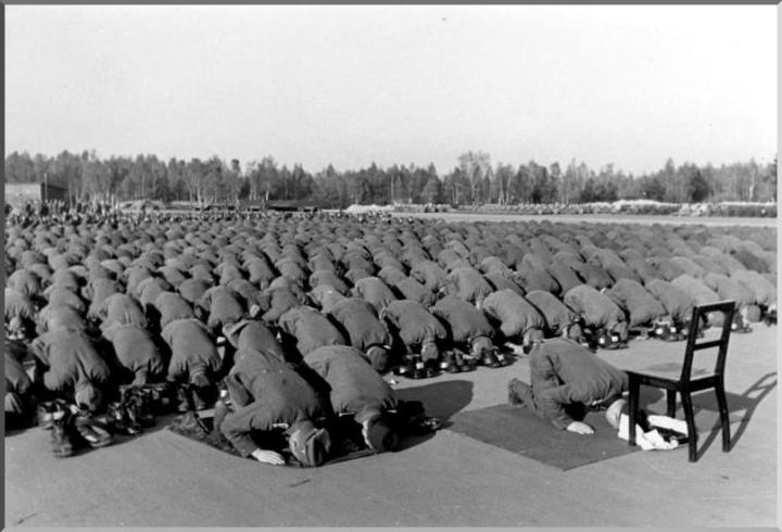 17. Muslim members of the Waffen-SS 13th division, during world war II, stop to pray, (1942)