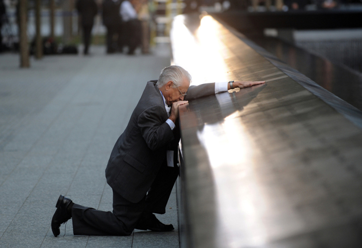 Robert Peraza pauses at his son’s name on the 911 Memorial during the tenth anniversary ceremonies at the site of the World Trade Center