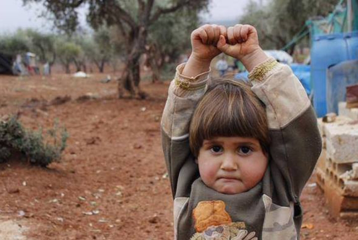a four-year-old Syrian girl 'surrendered' when a photographer pointed his camera at her... and she assumed it was a gun
