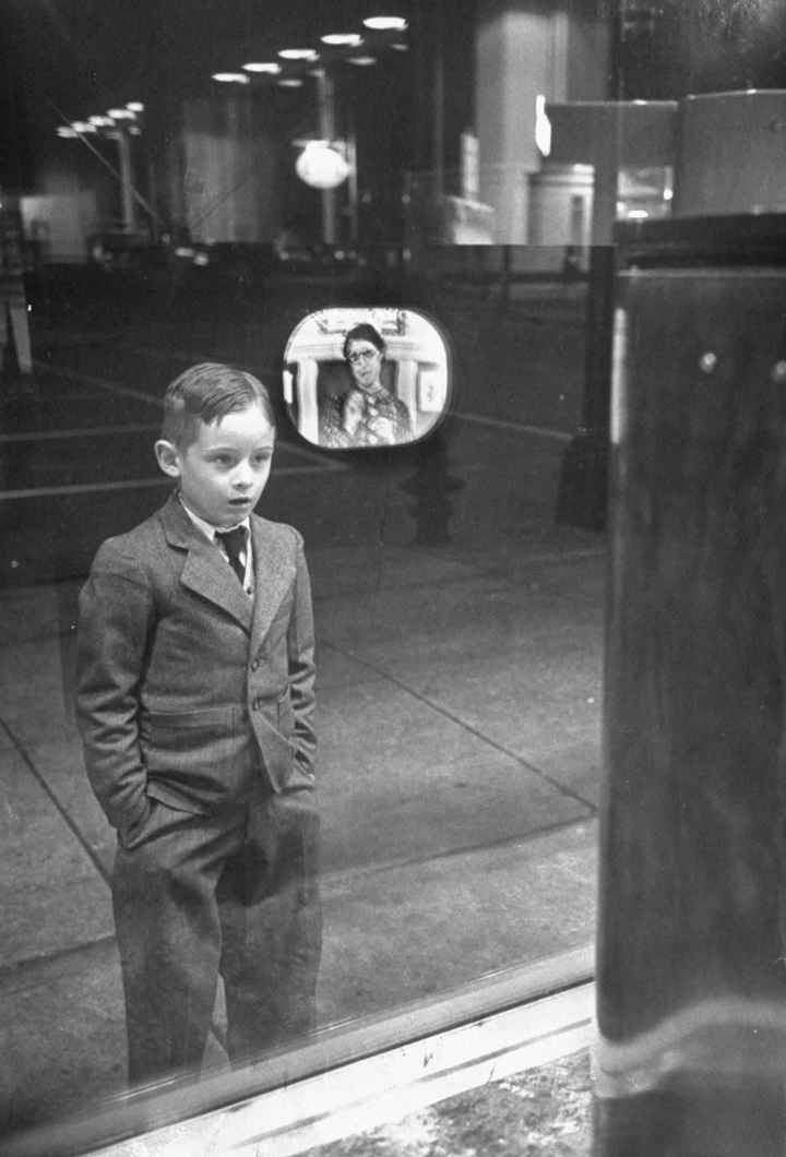11. Boy watching TV for the first time in an appliance store window, 1948