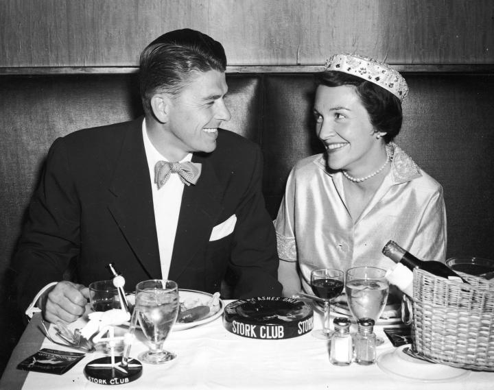 25. Ronald Reagan and his wife Nancy Reagan smile as they have their honeymoon dinner at the Stork Club in New York City, 1952