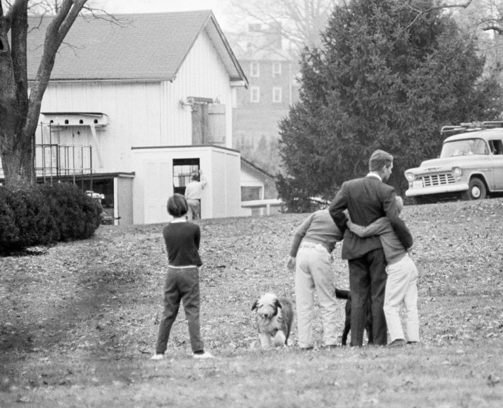 3. Attorney General Robert Kennedy is comforted by two of his children on the lawn of his home, after he had been notified of the assassination of his brother, November 22, 1963
