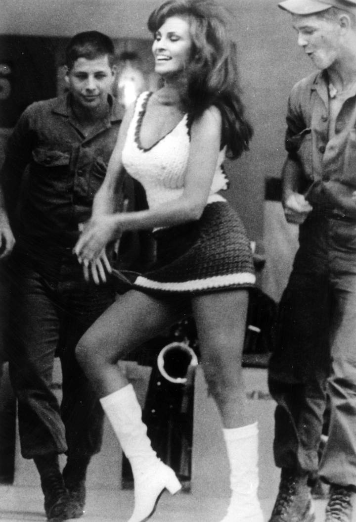 35. Two GIs admire actress Raquel Welch while she was visiting the troops in Vietnam, 9th January 1968
