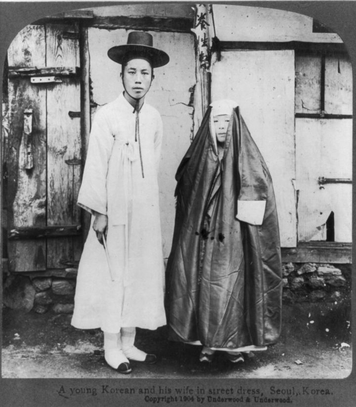 A young Korean husband and wife in street dress, Seoul, Korea. 1904.