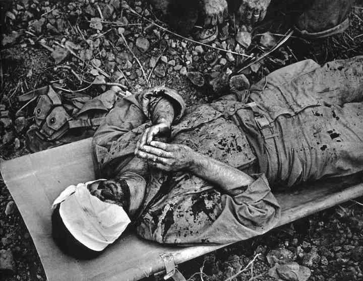 19. Wounded American soldier praying, Okinawa, 1945