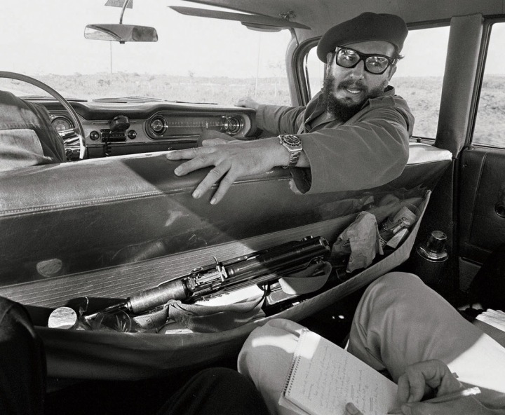 27. Fidel Castro giving an interview in his car.1964