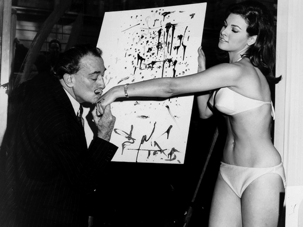 30. Salvador Dalí kisses 25-year-old Raquel Welch's hand in front of his abstract portrait of her, 1965.