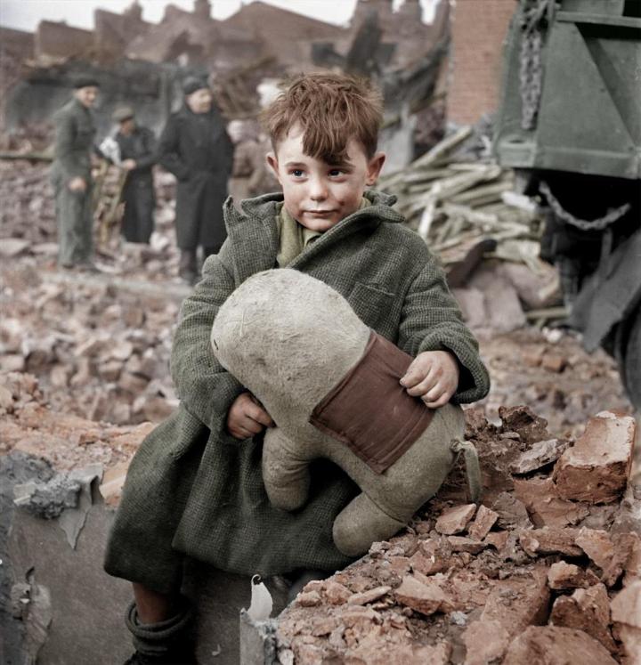 1. Abandoned boy holding a stuffed toy animal. London 1945.