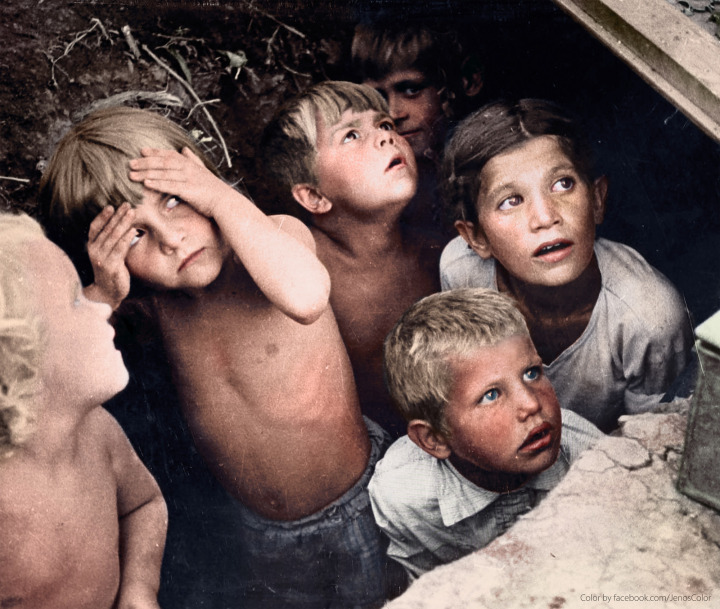 29. Children watch as their neighborhood is bombed in Minsk, Belorussia. The bombing was part of Operation Barbarossa. June, 1941.