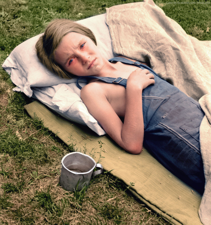 31. A child of a migrant family lies sick in Yakima Valley, Washington, 1939.