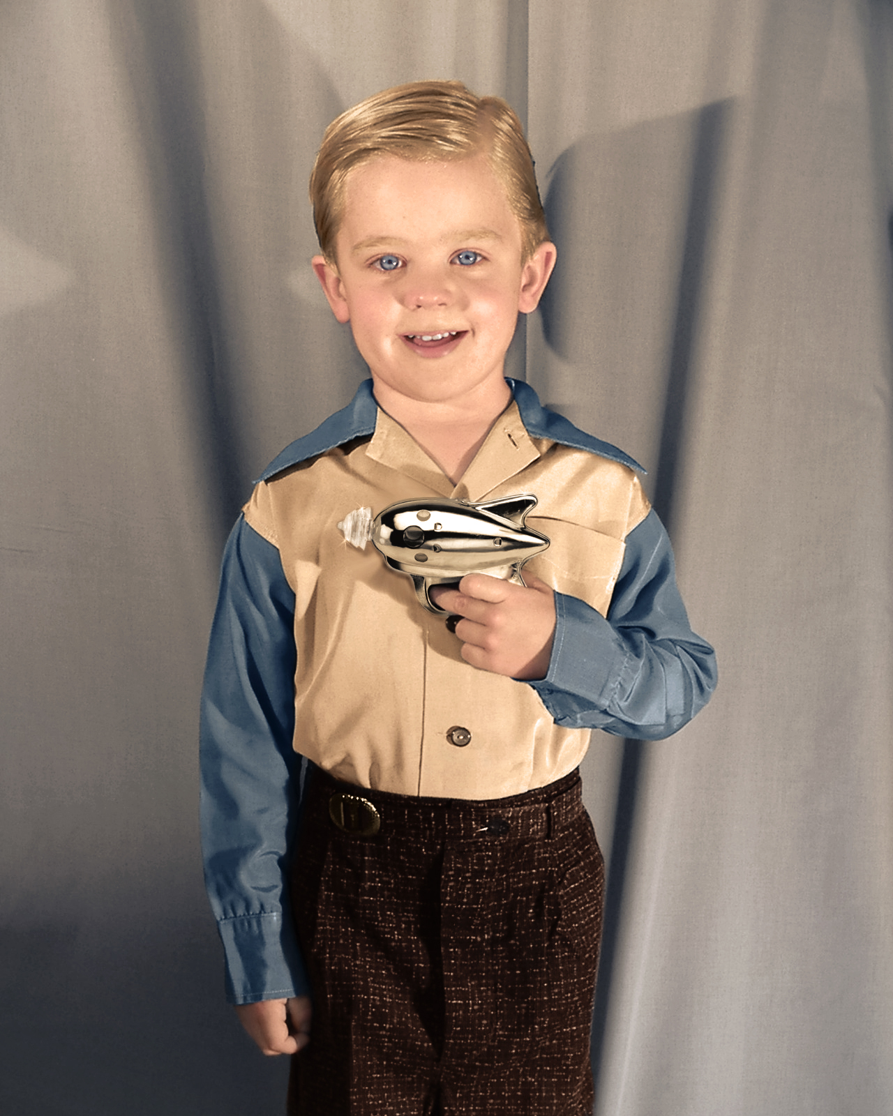 15. A boy shows off his ray gun, around the 1950s