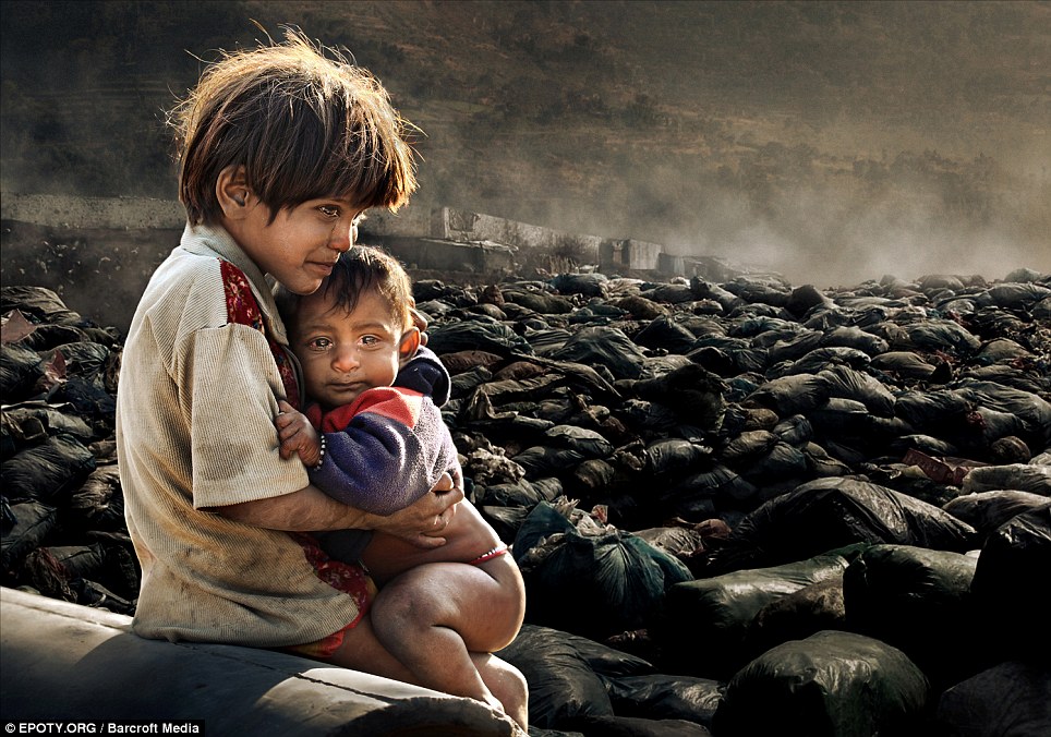 10. A haunting yet sad image of two children who live by scavenging on a junkyard in Kathmandu, Nepal.