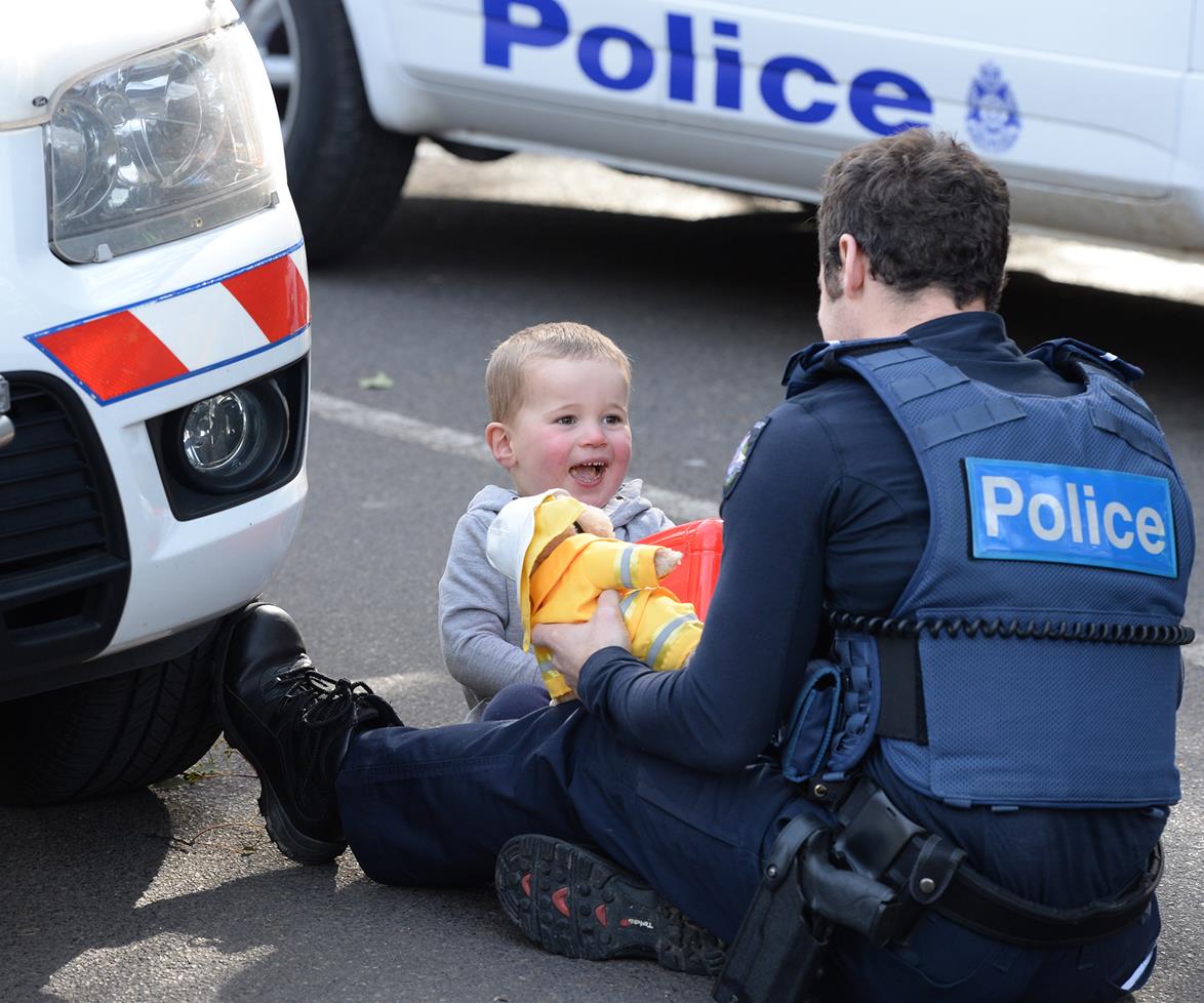 13. Victorian Police Constable, Ben Timpson keeps company Two-Year-Old Flint. While his mother was trapped underneath a car, in Melbourne, Australia. 2015.