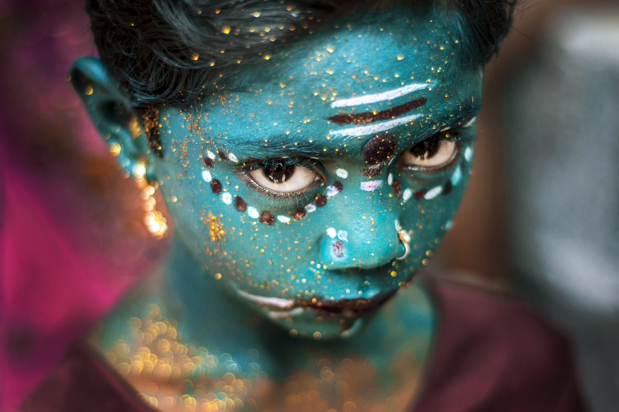 23. A girl with a face painted in aquamarine during the Maha Shivaratri in Kaveripattinam, India