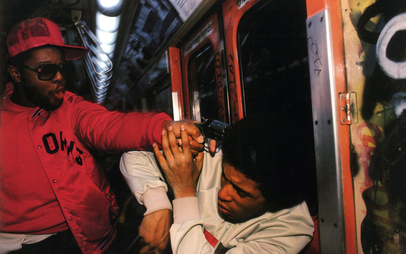 32. An undercover police officer apprehends a mugger on the New York City Subway, 1980.