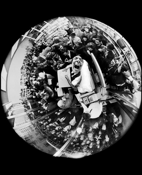 35. Salvador Dali at a book signing, taken with a fisheye lens, by Philippe Halsman, 1963.